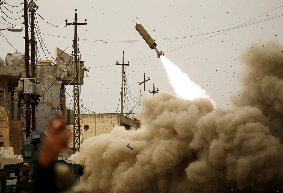 Iraqi rapid response members fire a missile against Islamic State militants during a battle with the militants in Mosul, Iraq. PHOTO: AFP