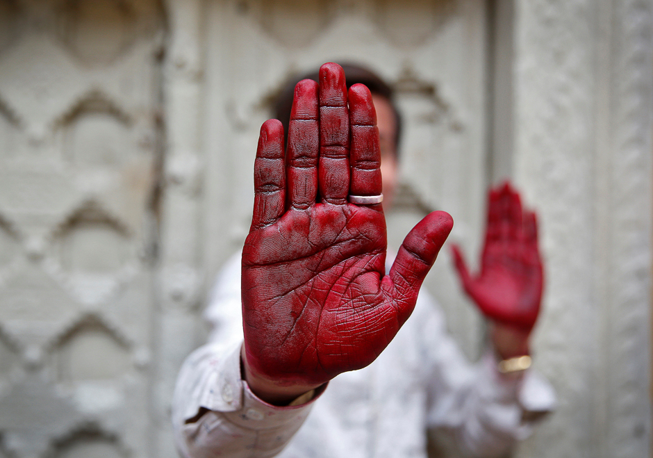 A Hindu devotee displays his inked hand after taking part in the religious festival of Holi in Vrindavan, in the northern state of Uttar Pradesh, India. PHOTO: REUTERS