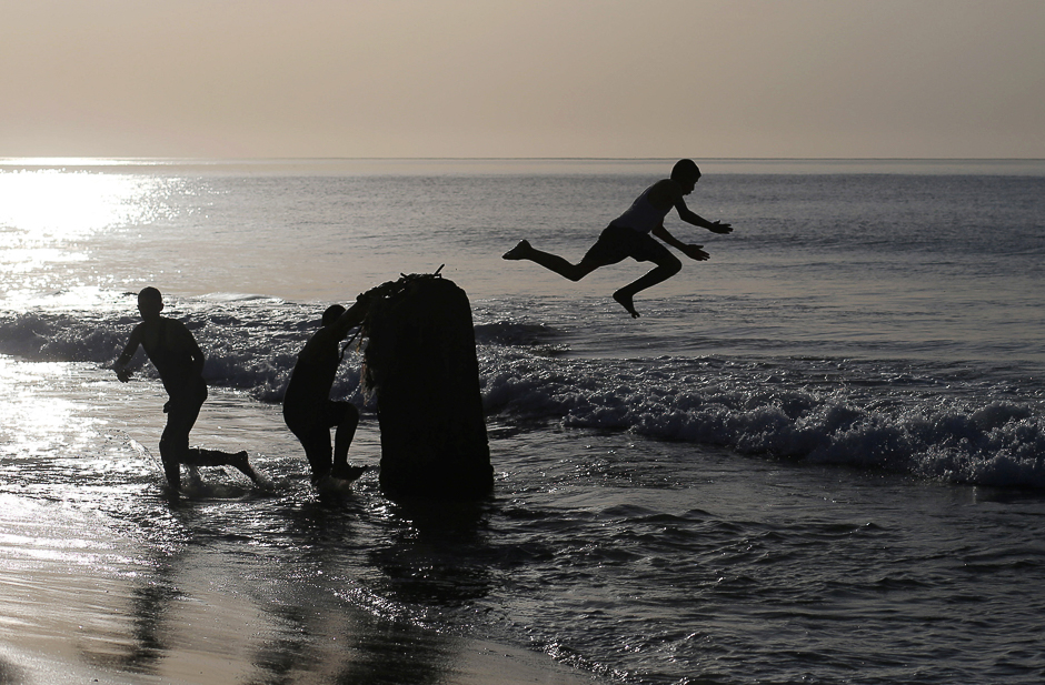 A Palestinian youth jumps into the seawater on a beach in Gaza City. PHOTO: REUTERS