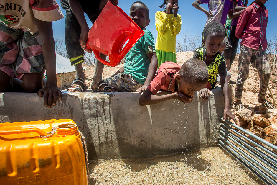 Children drink water delivered by a truck in the drought-stricken Baligubadle village near Hargeisa, the capital city of Somaliland, in this handout picture provided by The International Federation of Red Cross and Red Crescent Societies. PHOTO: REUTERS