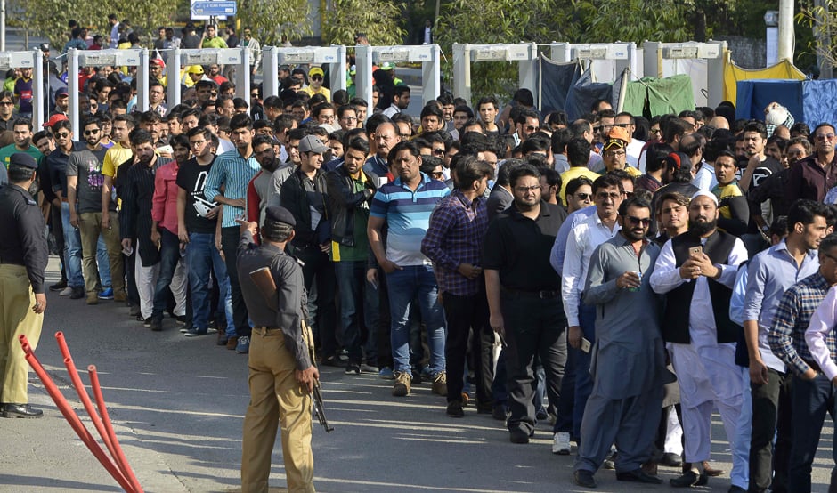 Pakistani spectators queue at one of entry gate of The Gaddafi Cricket Stadium. PHOTO: AFP