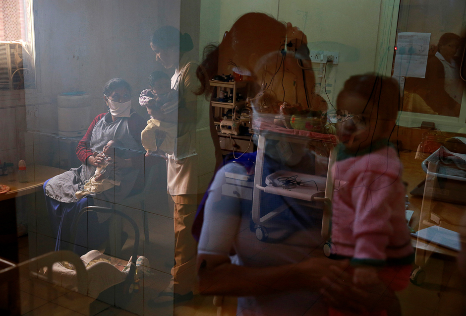 Nurses care for abandoned infants at the Palna facility in Delhi, India. PHOTO: REUTERS