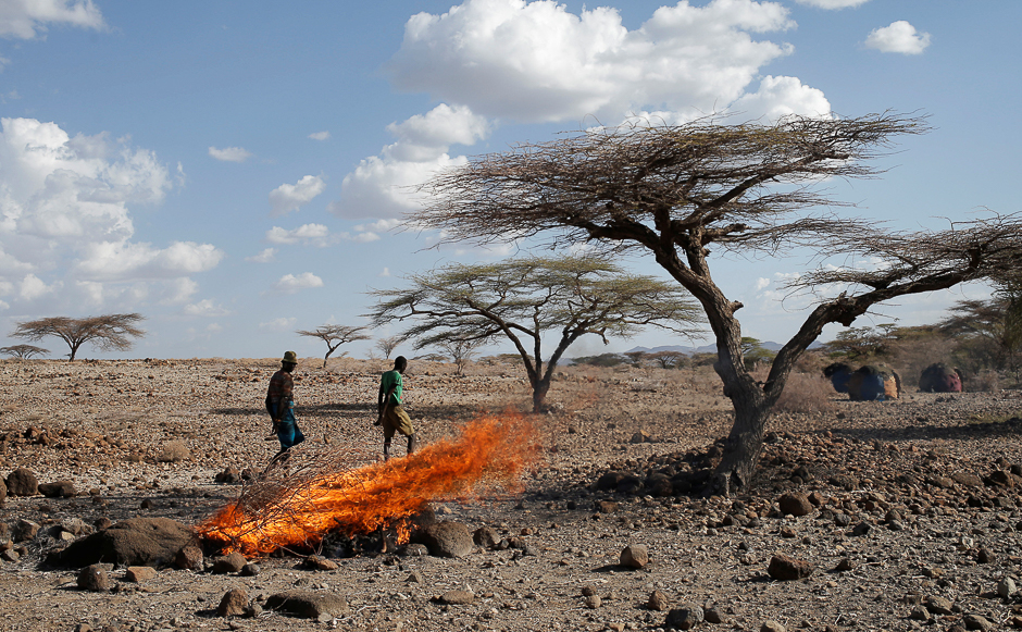 A Turkana tribesman walks in front of burned goats' carcasses in a village near Loiyangalani, Kenya. PHOTO: REUTERS