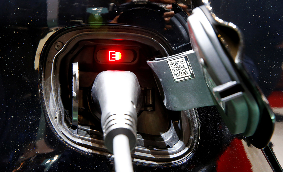 A Smart Fortwo Cabrio Electic Drive car is plugged at a recharging station. PHOTO: REUTERS