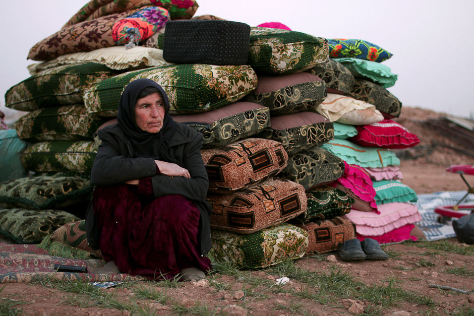 An internally displaced Syrian woman rests near cushions in Manbij city, in Aleppo Governorate, Syria. PHOTO: REUTERS
