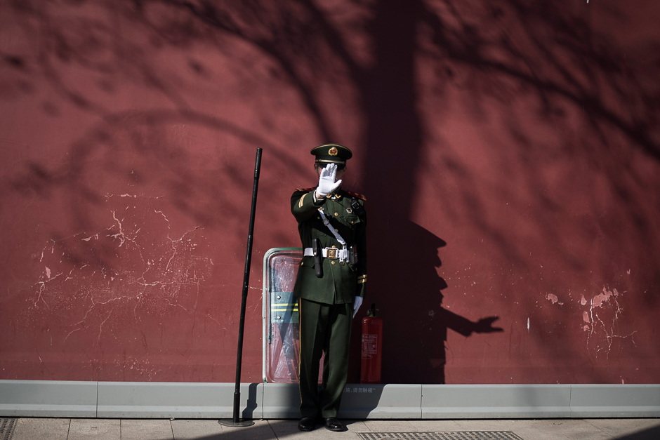 A paramilitary guard gestures not to be photographed at the gate of the Forbidden City ahead of upcoming opening sessions of the Chinese People's Political Consultative Conference (CPPCC) and the National People's Congress (NPC) in Beijing. PHOTO: AFP
