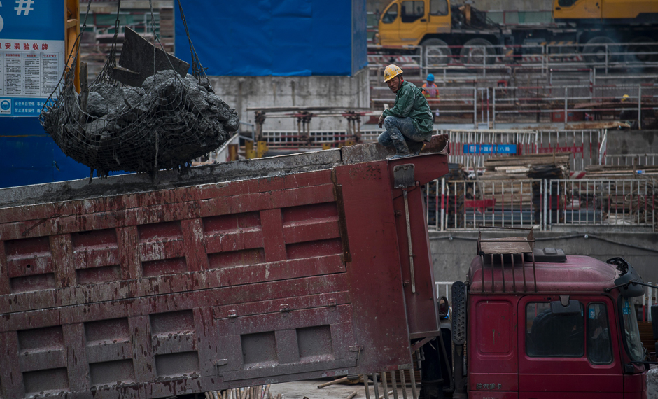 A man works on a truck at a construction site for a high-rise building in Shanghai. PHOTO: AFP