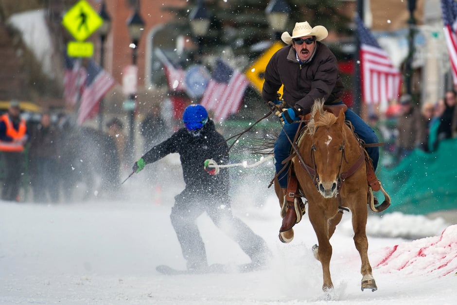 Rider Jorge Calzadillas races down Harrison Avenue while towing a skier during the 68th annual Leadville Ski Joring weekend competition in Leadville, Colorado. PHOTO: AFP