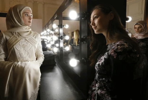 Models gather backstage before a show of the Firdaws fashion house led by Aishat Kadyrova, daughter of the Chechen Republic head Ramzan Kadyrov, at the Mercedes-Benz Fashion Week Russia in Moscow, Russia, March 17, 2017. PHOTO: REUTERS