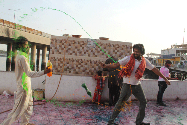 People throw colours on each other at Shri Lakshmi Narayan Mandir. PHOTO: AYESHA MIR