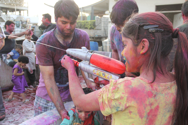 A child plays with a water gun during Holi at Shri Lakshmi Narayan Mandir. PHOTO: AYESHA MIR
