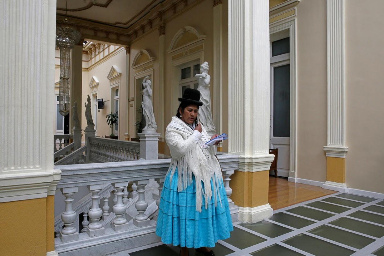 Elizabeth Mamani, 36, reporter at Radio Union, poses inside Bolivia's national congress building. 