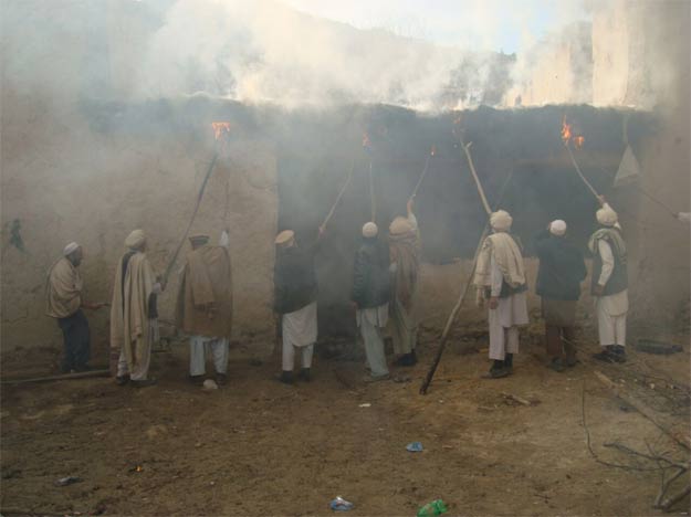 TTP militantâs house set ablaze. PHOTO: EXPRESS