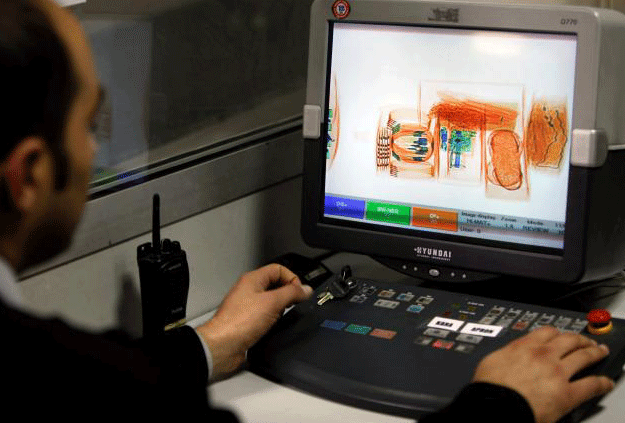 A security official looks at a screen displaying X-ray screened parcels in Turkish Post's (PTT) postal logistic centre at the Ataturk International airport in Istanbul, Turkey on November 6, 2010. PHOTO: REUTERS