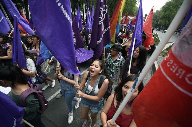 Women take part in the commemoration of International Women's Day on Reforma Avenue in Mexico City on March 8, 2017. PHOTO: AFP