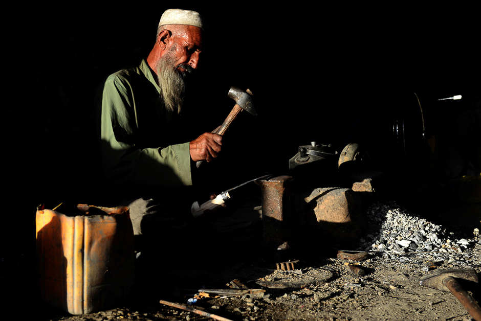 An Afghan blacksmith works at a shop in Kandahar. PHOTO: AFP