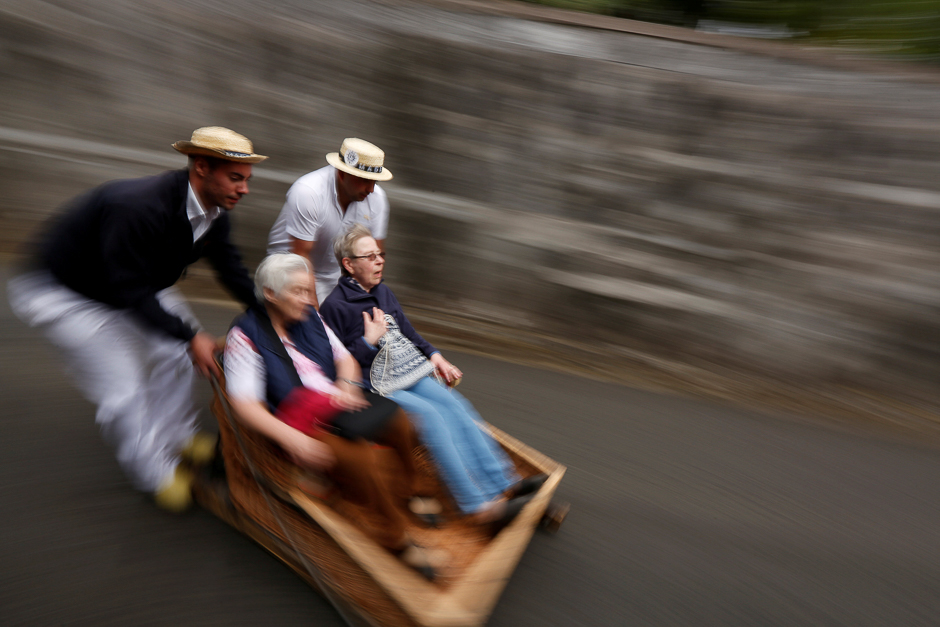 Runners push a basket sledge as they descend towards Funchal, Portugal. PHOTO: REUTERS