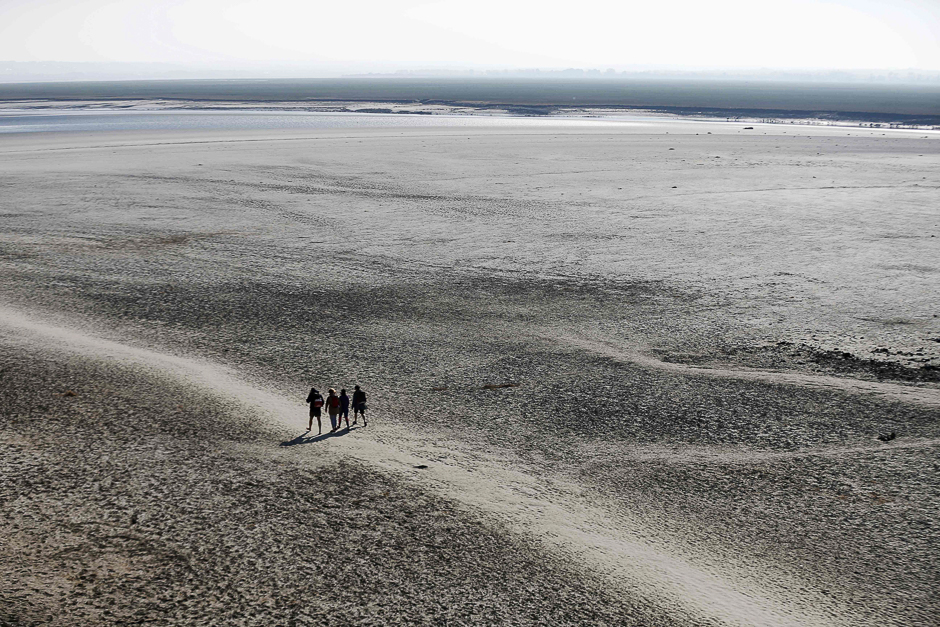 People walk near the Mont-Saint-Michel in northwestern France. PHOTO: AFP