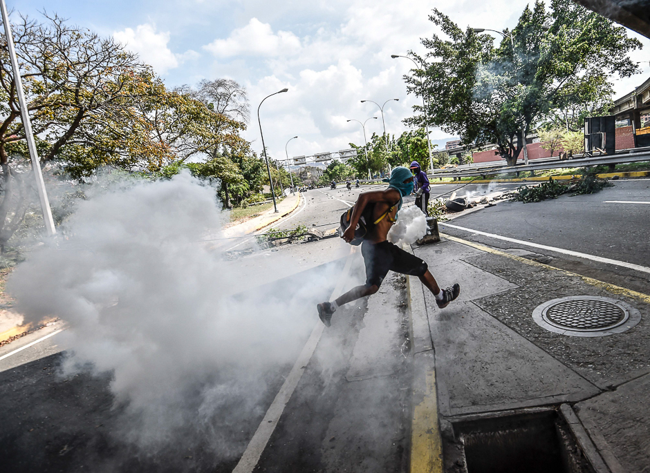 Venezuelan opposition activists clash with police forces during a demonstration against President Nicolas Maduro in Caracas. PHOTO: AFP