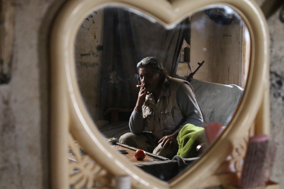 Abu Haitham, a 57-year-old rebel fighter from the Free Syrian Army's 18 March Division, sits in a building on the front line in the southern city of Daraa. PHOTO: AFP