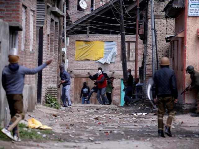 Kashmiri demonstrators (C) chuck stones towards Indian policemen during a criticism opposite by-polls in Srinagar Apr 9, 2017. PHOTO: REUTERS