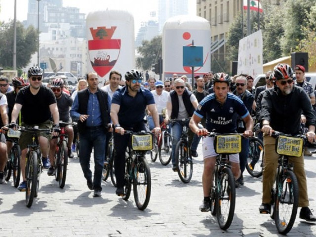 Lebanese Prime Minister Saad Hariri (C) rides a bike at an event to launch a public bicycle-sharing system in Beirut on April 30, 2017. PHOTO: AFP