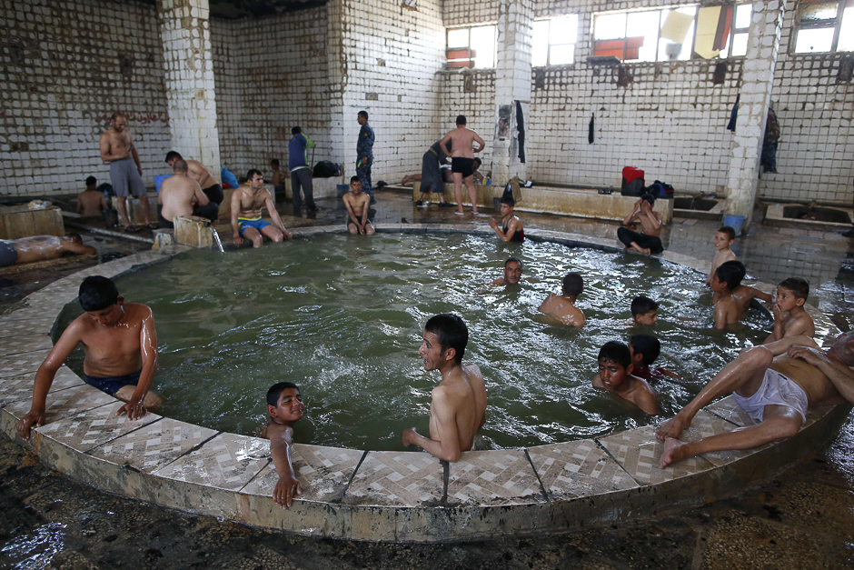 Iraqis bathe in a sulphur pond in the Hamam al-Alil area, about 14 kilometres from the southern outskirts of Mosul. PHOTO: AFP