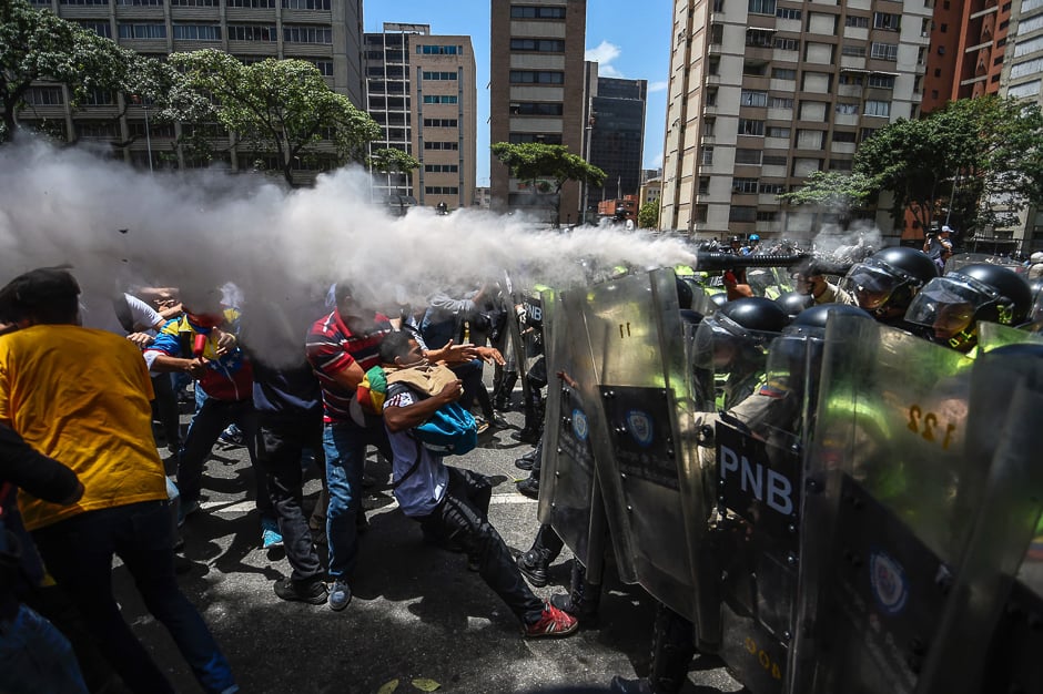 Venezuela's opposition activists clash with riot police agents during a protest against Nicolas Maduro's government in Caracas. PHOTO: AFP