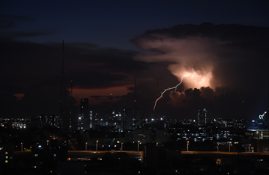 An electrical storm passes after the sun sets in Bangkok. PHOTO: AFP