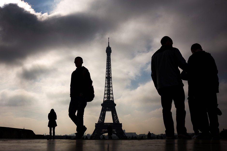 People walk in front of the Eiffel tower in Paris. PHOTO: AFP