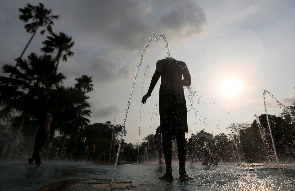 A boy plays with water fountains on a hot day in Colombo, Sri Lanka. PHOTO: REUTERS