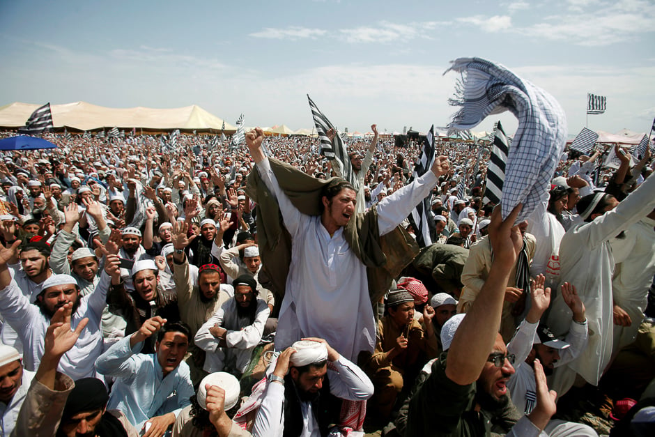Supporters of the Jamiat Ulema-i-Islam-Fazl religious party react as Sheikh Saleh bin Ibrahim Imam Qaba leads Friday Prayers in Nowshera, Pakistan. PHOTO: AFP
