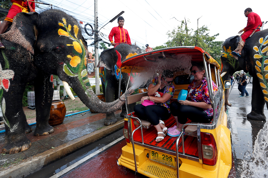 Elephants spray a tourist with water in celebration of the Songkran Water Festival in Ayutthaya province, north of Bangkok, Thailand. PHOTO: REUTERS