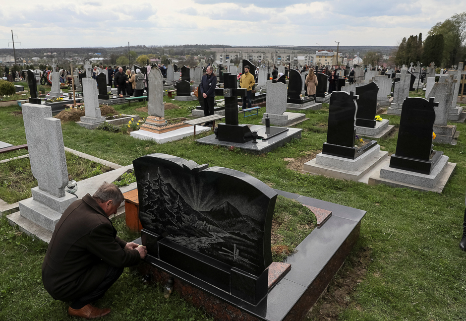 Greek-Catholic believers visit the graves of their loved ones to pay homage to them on the day of Easter in the township of Pustomyty, Ukraine. PHOTO: REUTERS