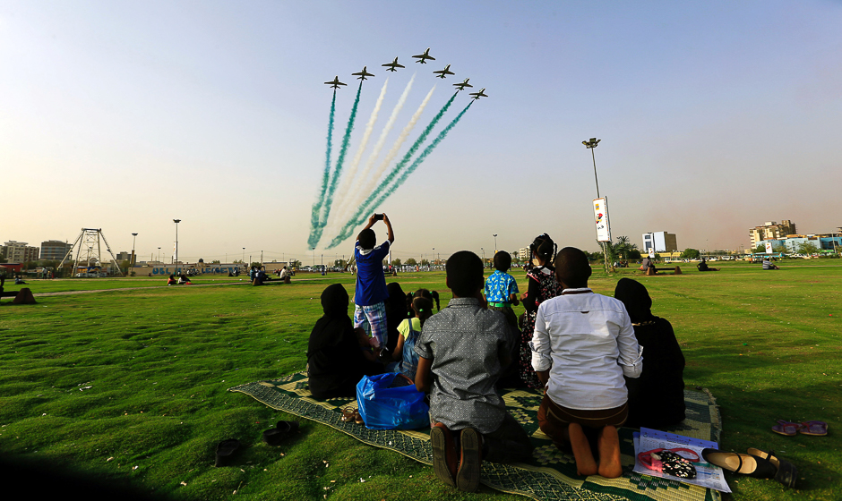 People look at Saudi Air Force perform from the Green Square near Khartoum Airport, Khartoum, Sudan. PHOTO: REUTERS