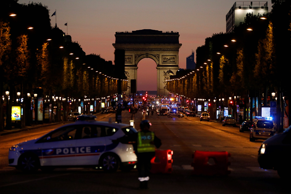 Police officers block the access to the Champs Elysees near the Arc de Triomphe in Paris after a shooting. PHOTO: AFP