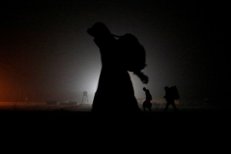 A group of migrants who said they were from Djibouti and Somalia walk along railway tracks after crossing the Canada-US. border in Emerson, Manitoba, Canada. PHOTO: REUTERS