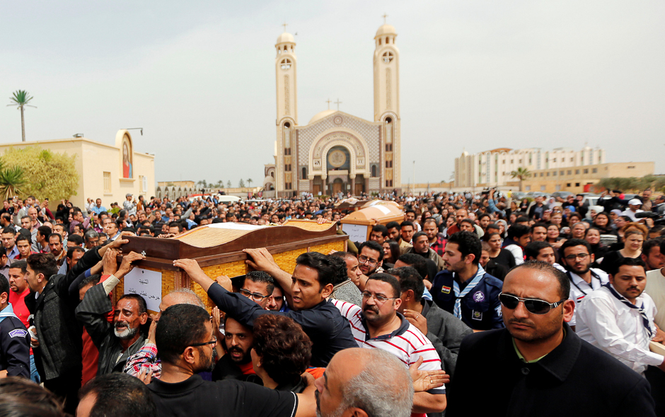Relatives mourn the victims of the Palm Sunday bombings during the funeral at the Monastery of Saint Mina 