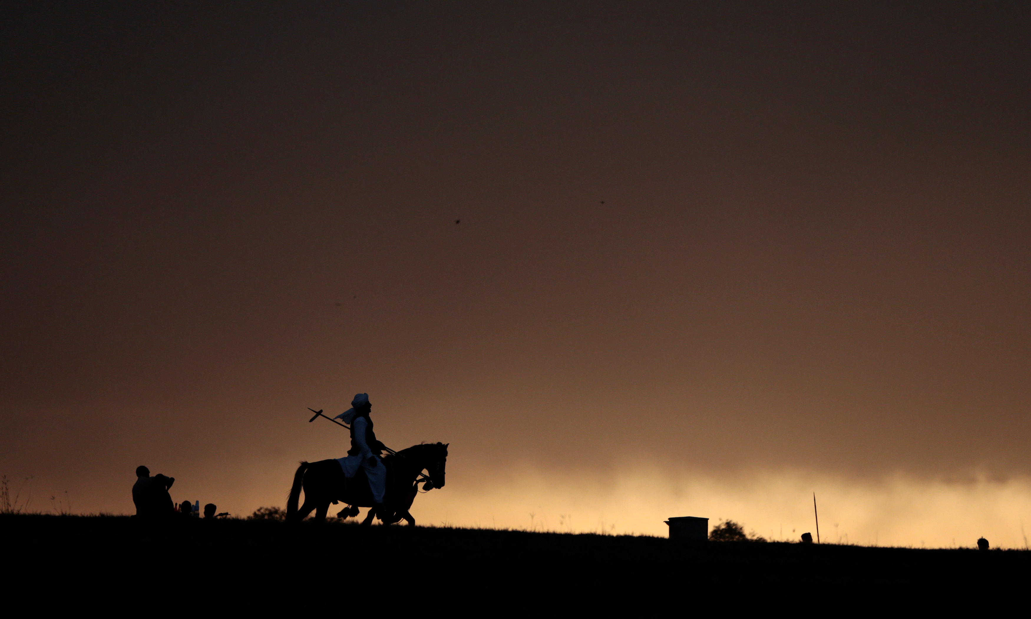 A rider on a horseback returns to the staging area after competing in a tent pegging competition in Islamabad. PHOTO: REUTERS