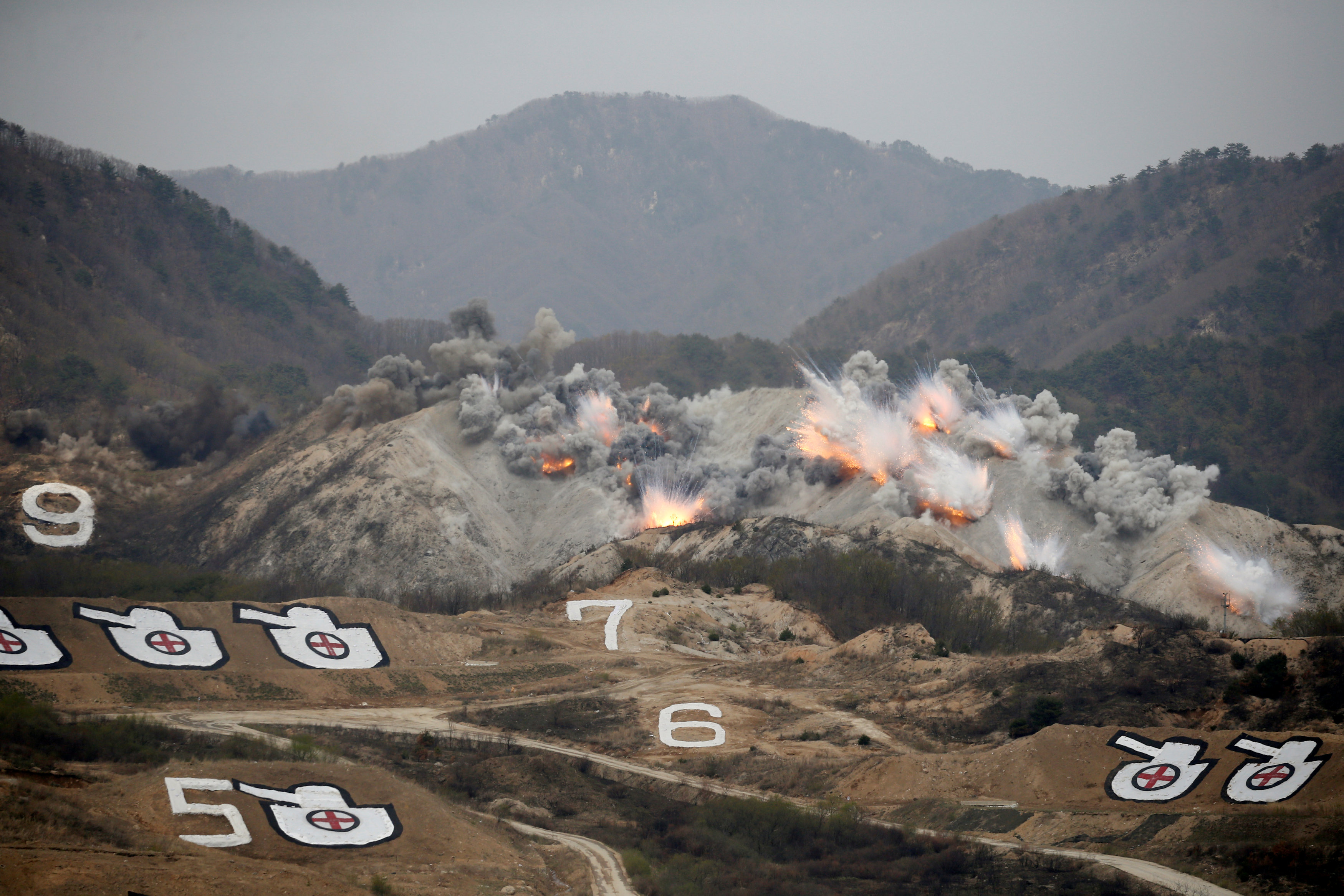 Explosions are seen at a target, during a U.S.-South Korea joint live-fire military exercise, at a training field, near the demilitarized zone, separating the two Koreas in Pocheon, South Korea April 21, 2017. Picture taken on April 21, 2017. REUTERS/Kim Hong-Ji TPX IMAGES OF THE DAY