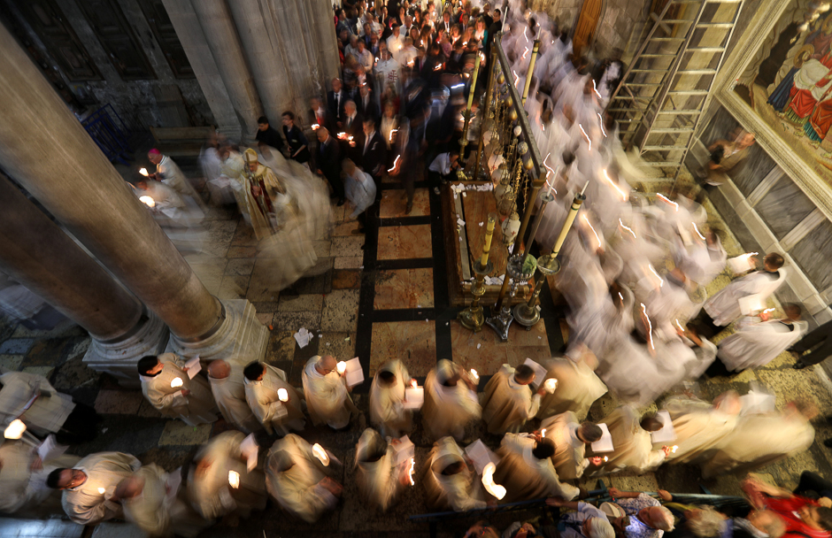 Christian worshippers take part in a Sunday Easter mass procession in the Church of the Holy Sepulchre in Jerusalem's Old City. PHOTO: REUTERS