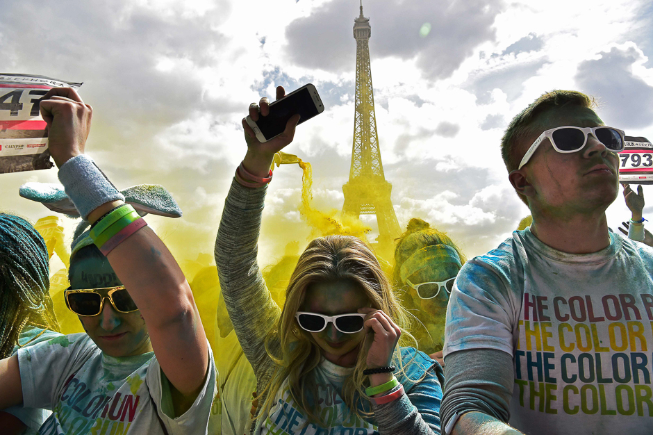 People take part in the Color Run 2017 's edition in front of the Eiffel Tower in Paris. PHOTO: AFP