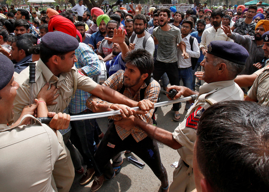 A university student scuffles with policemen during a protest against what the students say is hike in their fees in Chandigarh, India. PHOTO: REUTERS