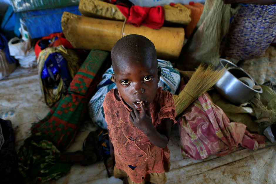 A displaced boy from South Sudan stands next to family belongings in Lamwo after fleeing fighting in Pajok town across the border in northern Uganda. PHOTO: REUTERS