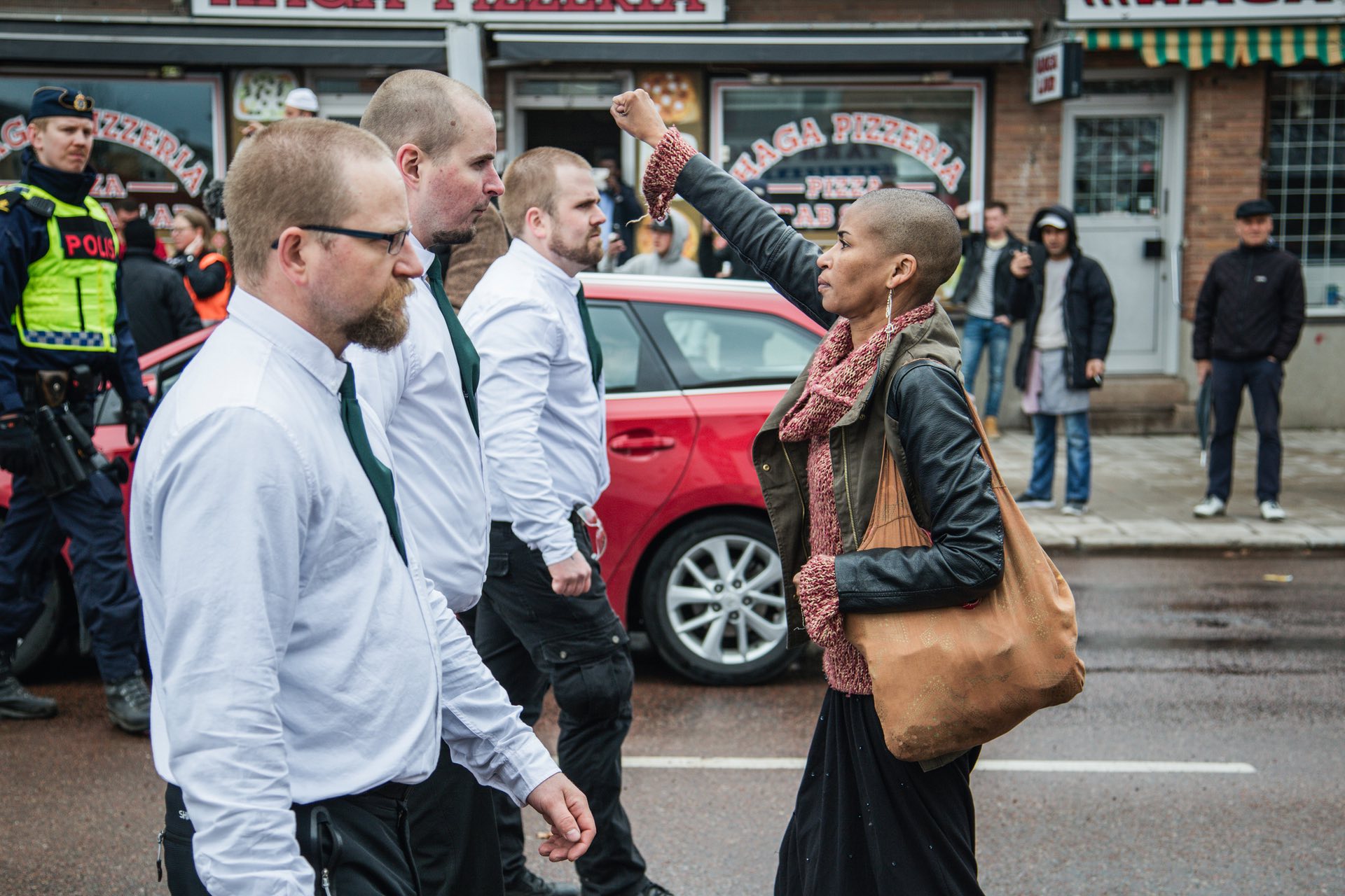 A lone woman stands up to uniformed demonstrators in a Nazi demonstration in BorlÃ¤nge, Sweden on 1 May 2015. PHOTO: AP