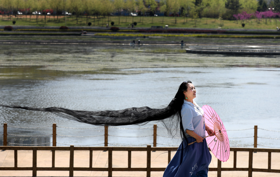 A woman with long hair poses for pictures in Weihai, Shandong province, China. PHOTO: REUTERS