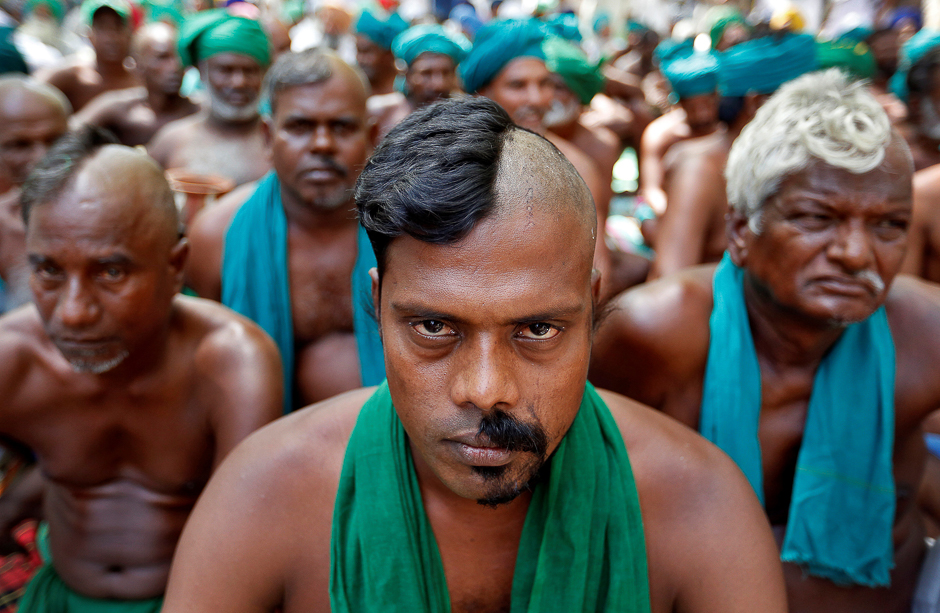 Farmers from the southern state of Tamil Nadu pose half shaved during a protest demanding a drought-relief package from the federal government, in New Delhi, India. PHOTO: REUTERS