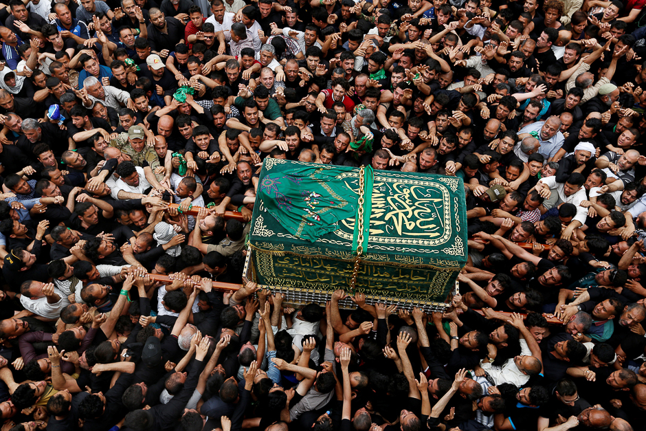 Shi'ite Muslim pilgrims carry a mock coffin during a symbolic funeral marking the death anniversary of Imam Moussa al-Kadhim shrine in Baghdad's Kadhimiya district, Iraq. PHOTO: REUTERS