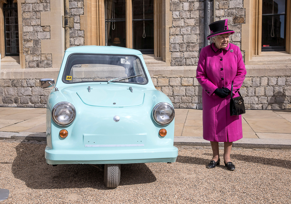 Britain's Queen Elizabeth stands next to an old subsidised, low cost mobility scooter from the 1960's, during a ceremony in Windsor Castle, Windsor. PHOTO: REUTERS