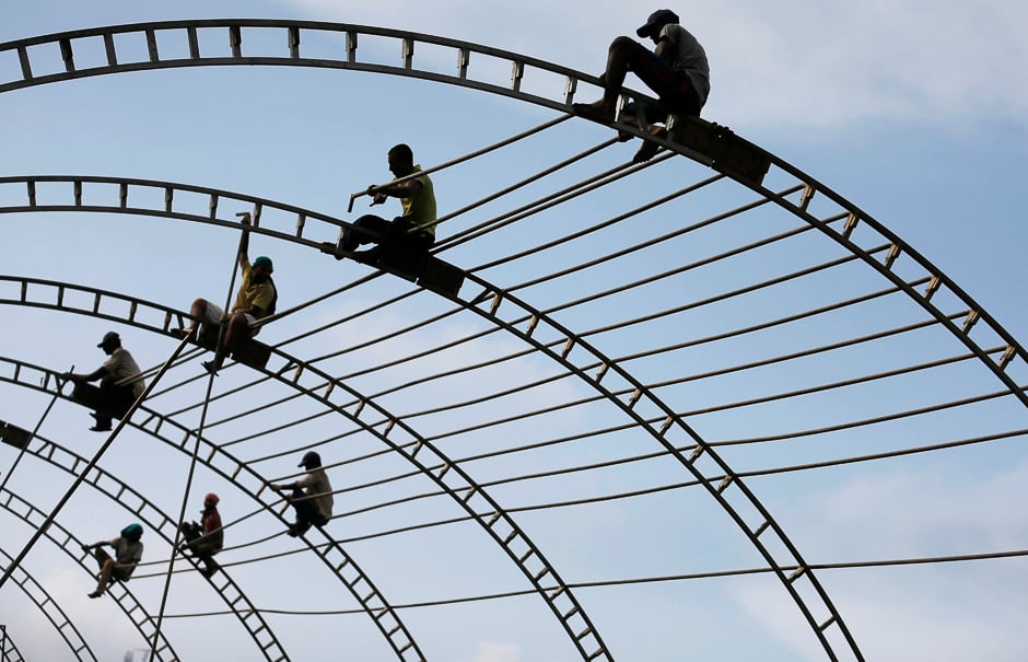 A Group of men working on top of a marquee for a ceremony in Colombo, Sri Lanka. PHOTO: REUTERS
